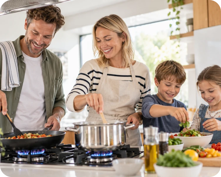 Family cooking together on a gas stove